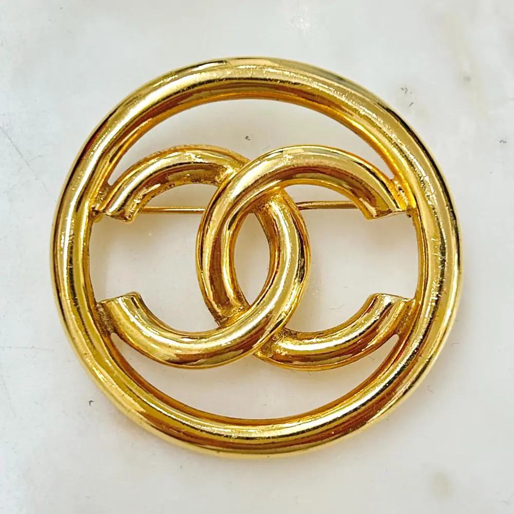 Chanel 1993 gold circle logo brooch