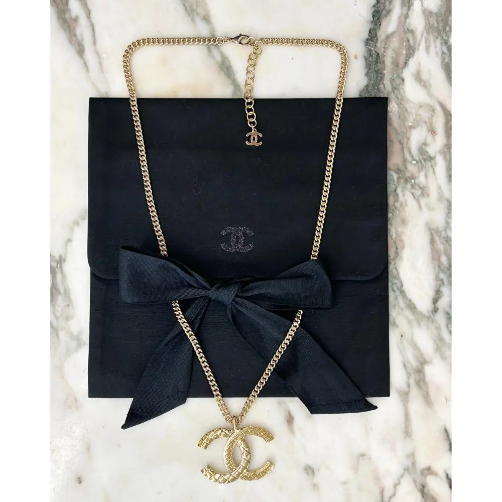 Chanel 2024 gold logo pendent necklace
