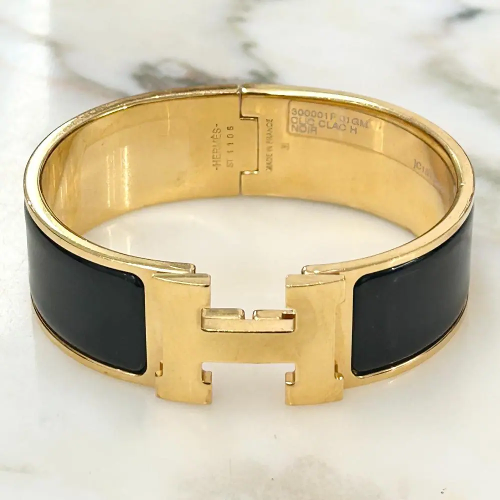 Hermès Clic Clac H bracelet in black enamel and gold plated metal