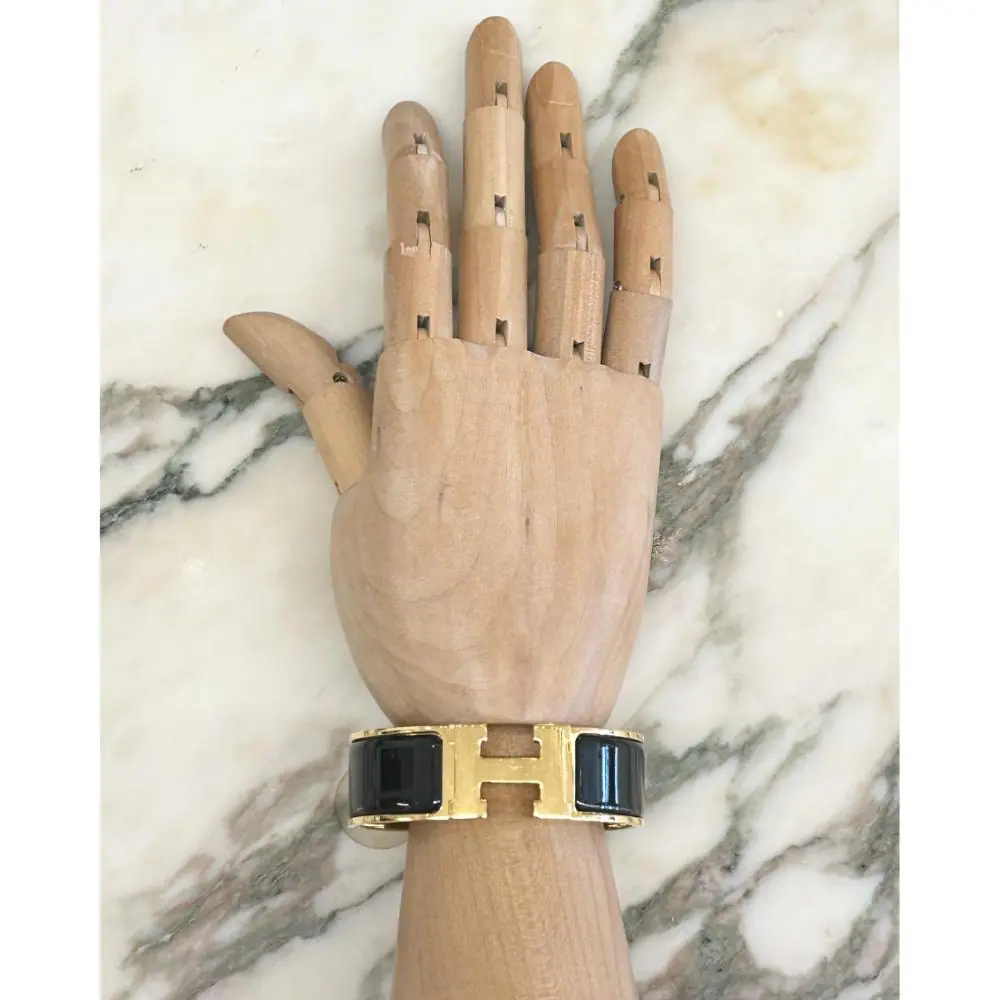 Hermès Clic Clac H bracelet in black enamel and gold plated metal
