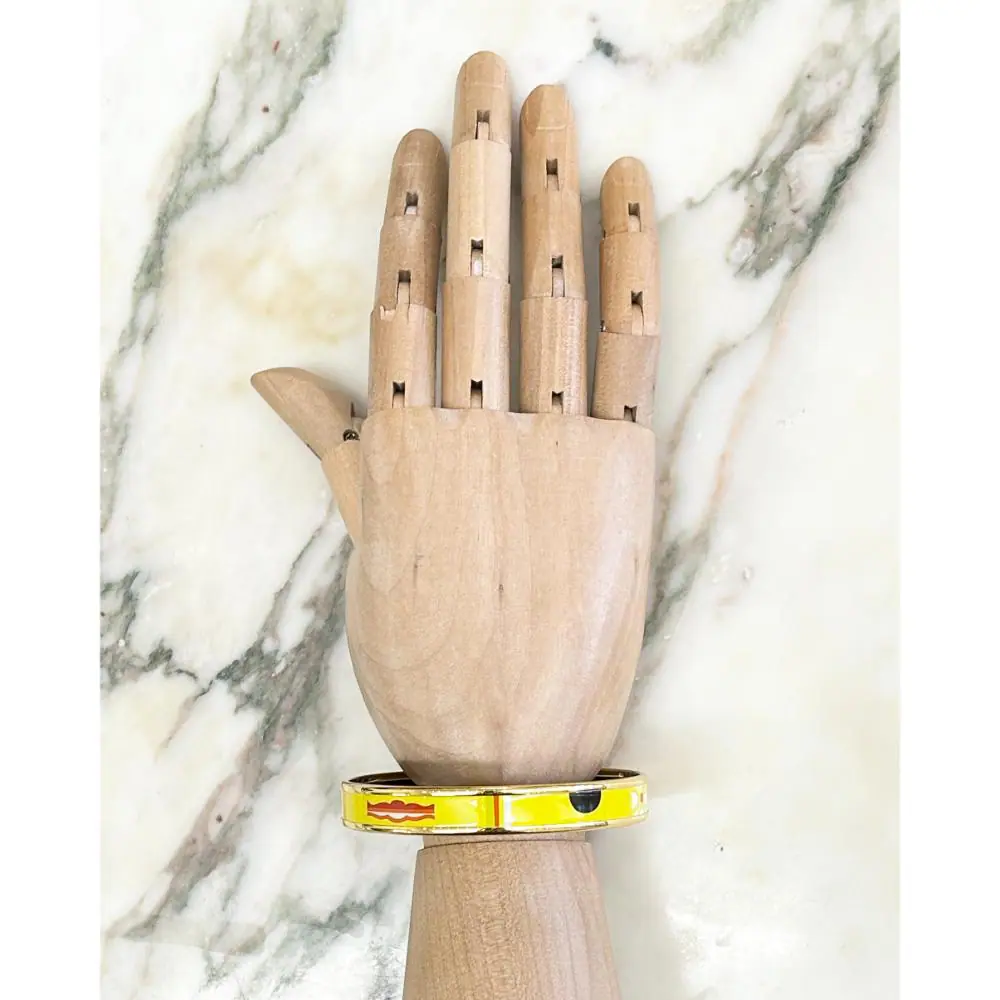 Hermès enamel abstract print bangle with gold plated trim