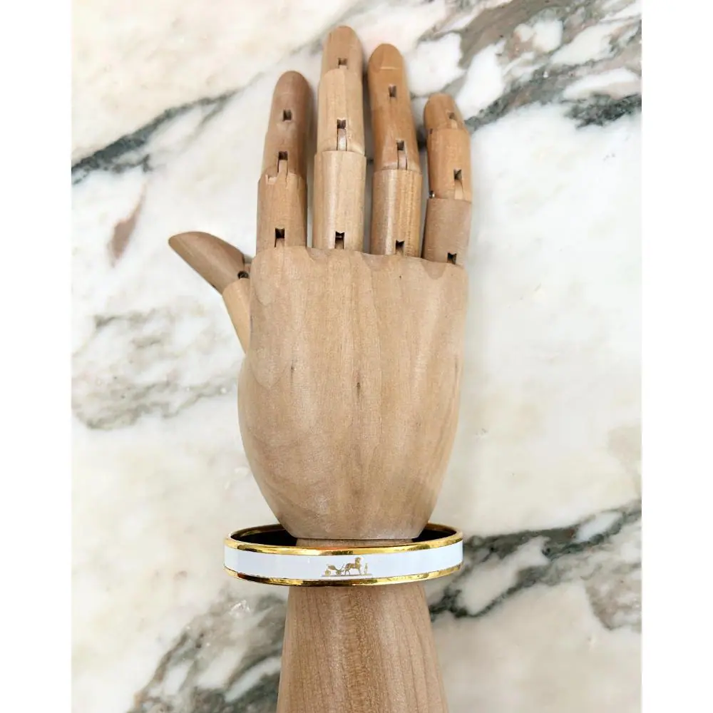Hermès white enamel Caleche bangle with gold trim