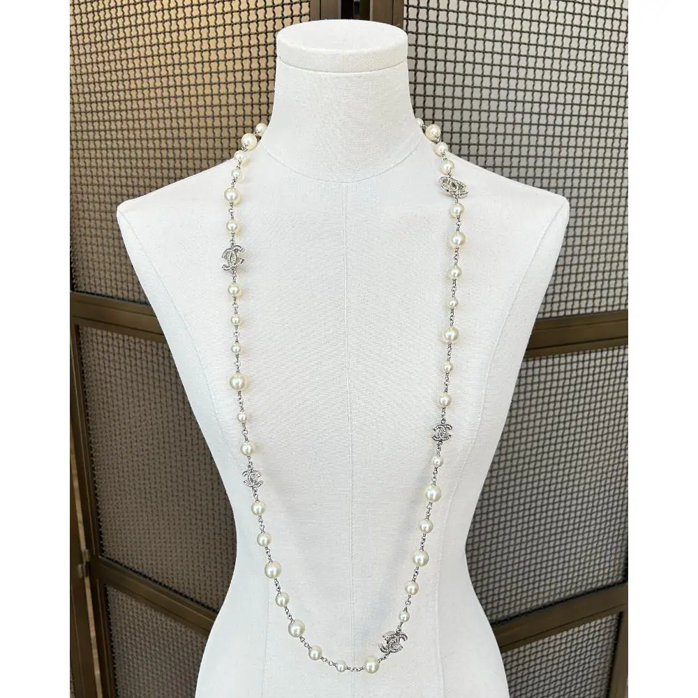 Chanel 2011 long pearl necklace with crystal logo charms