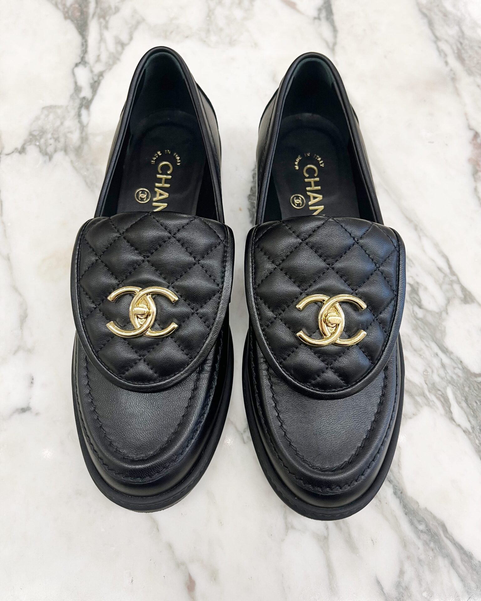 Chanel black quilted leather turn lock loafers