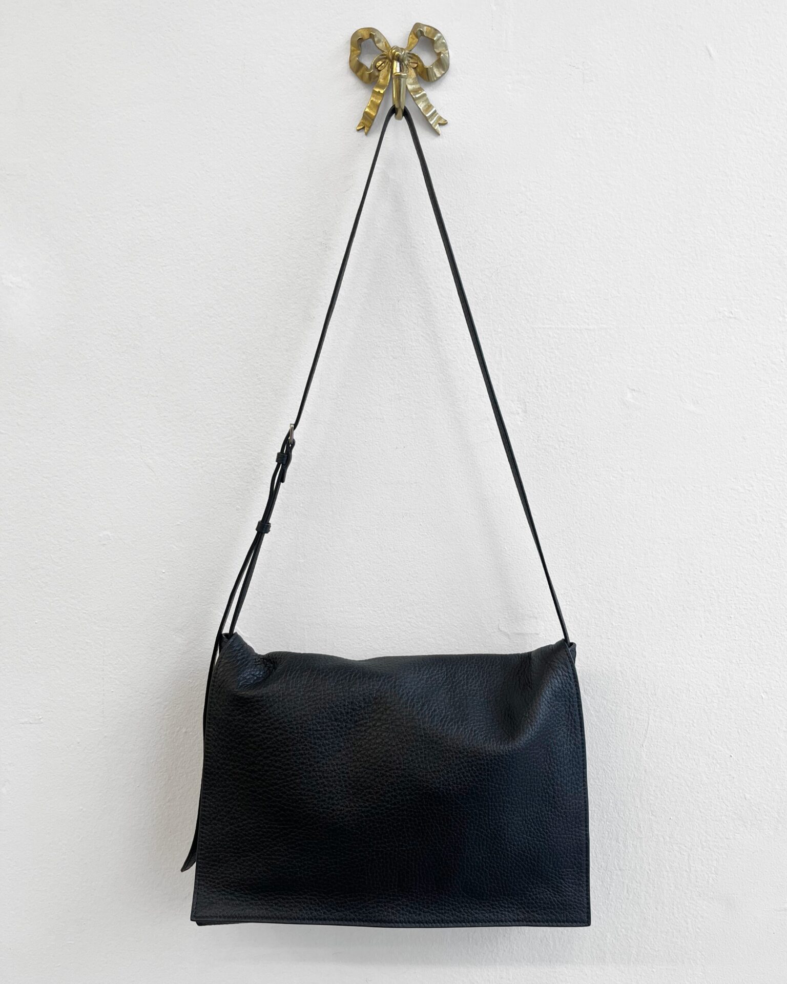 The Row Nan black pebbled leather messenger bag with pouch