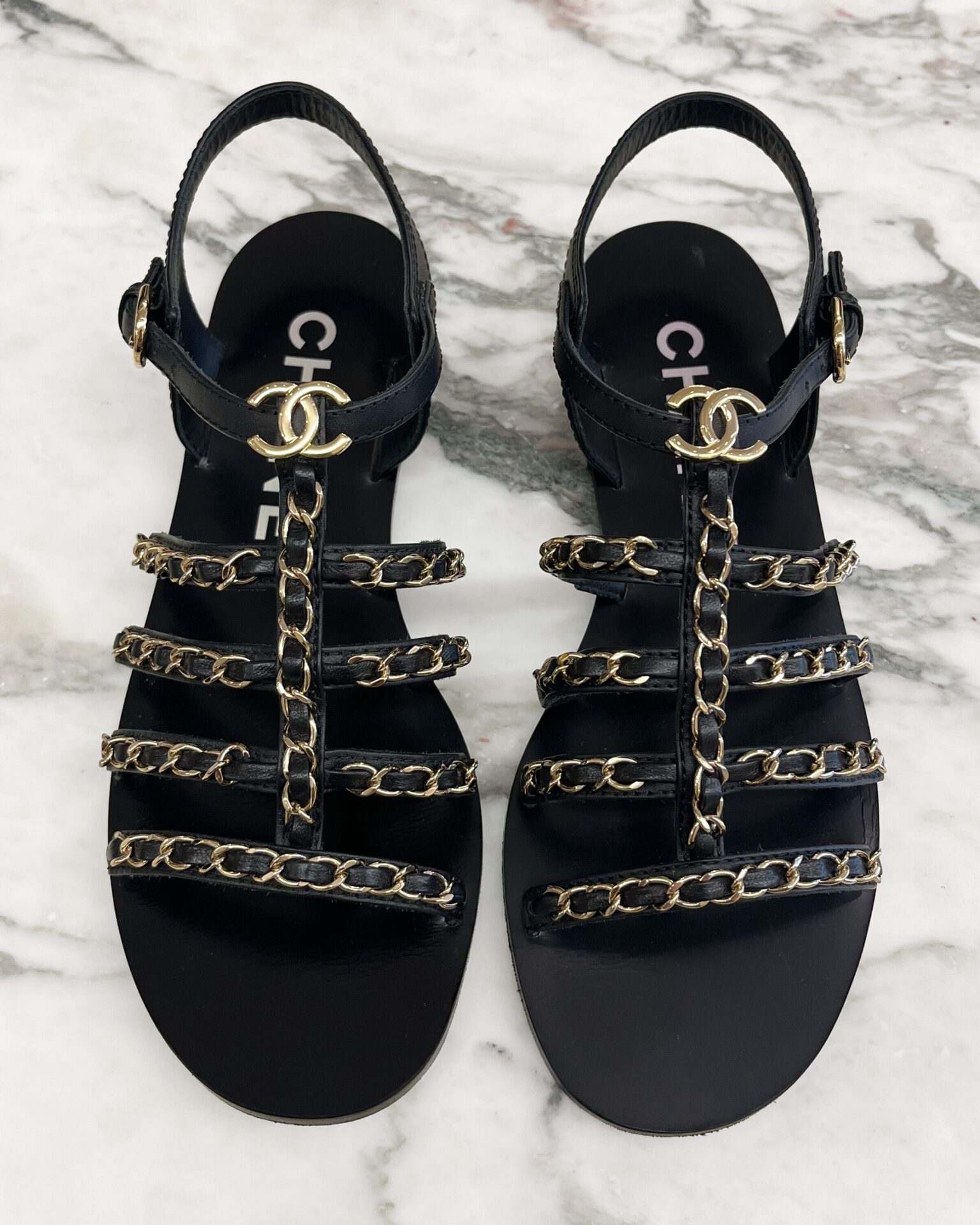 Chanel 2023 black strappy flat sandals with gold chains