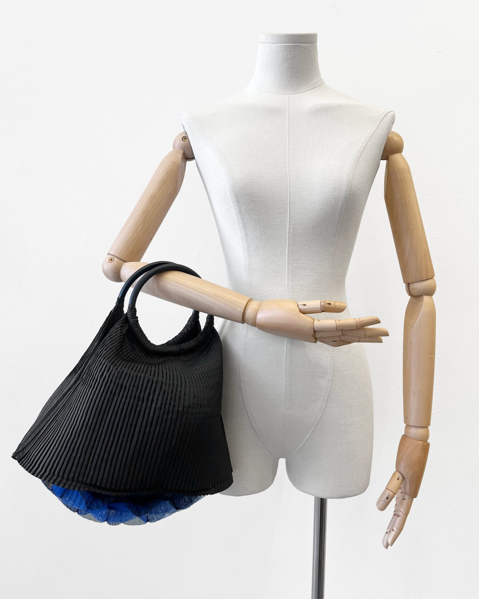 Issey Miyake Pleats Please black purse with indigo latticed bottom
