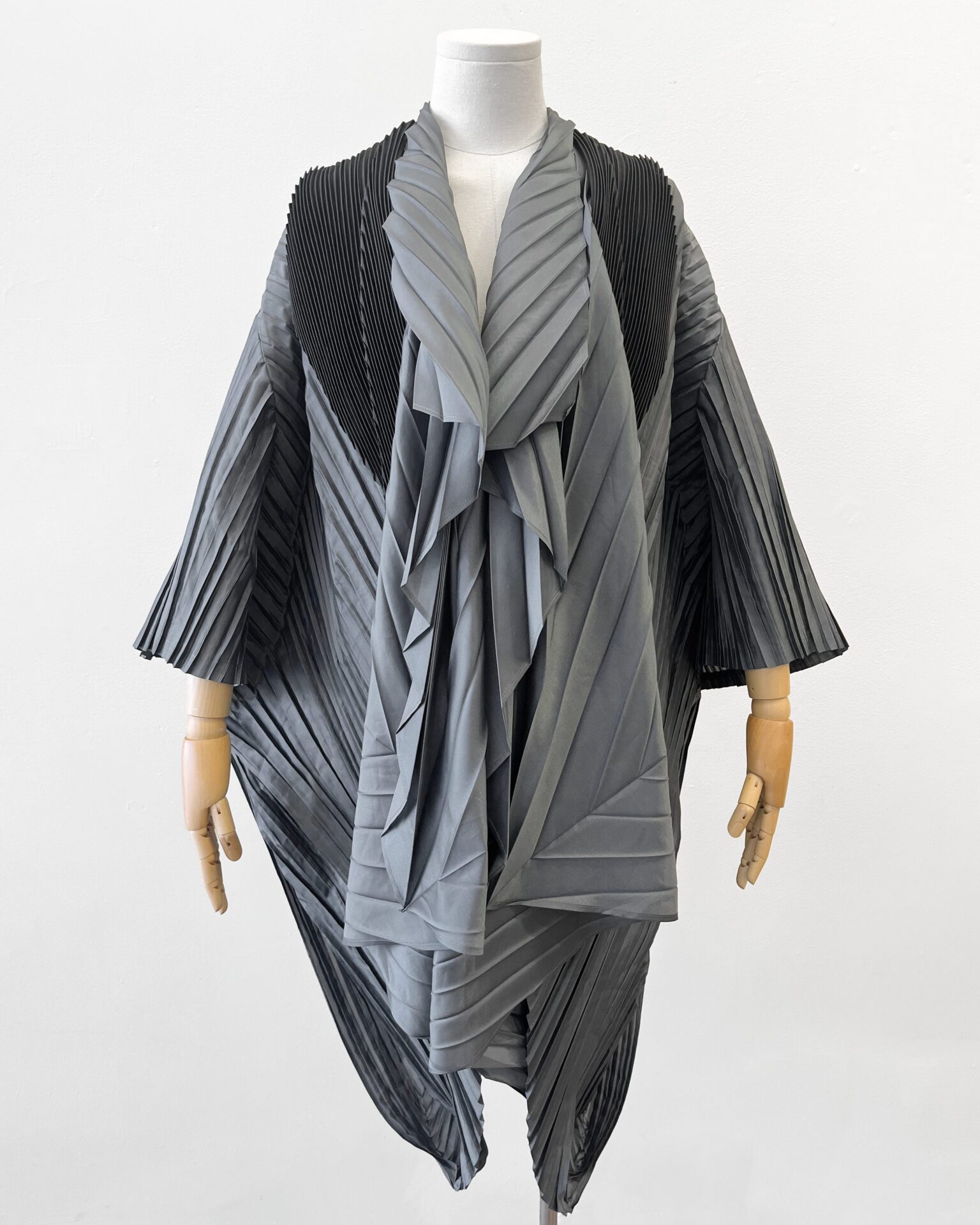 Issey Miyake grey pleated cocoon coat with black scarf