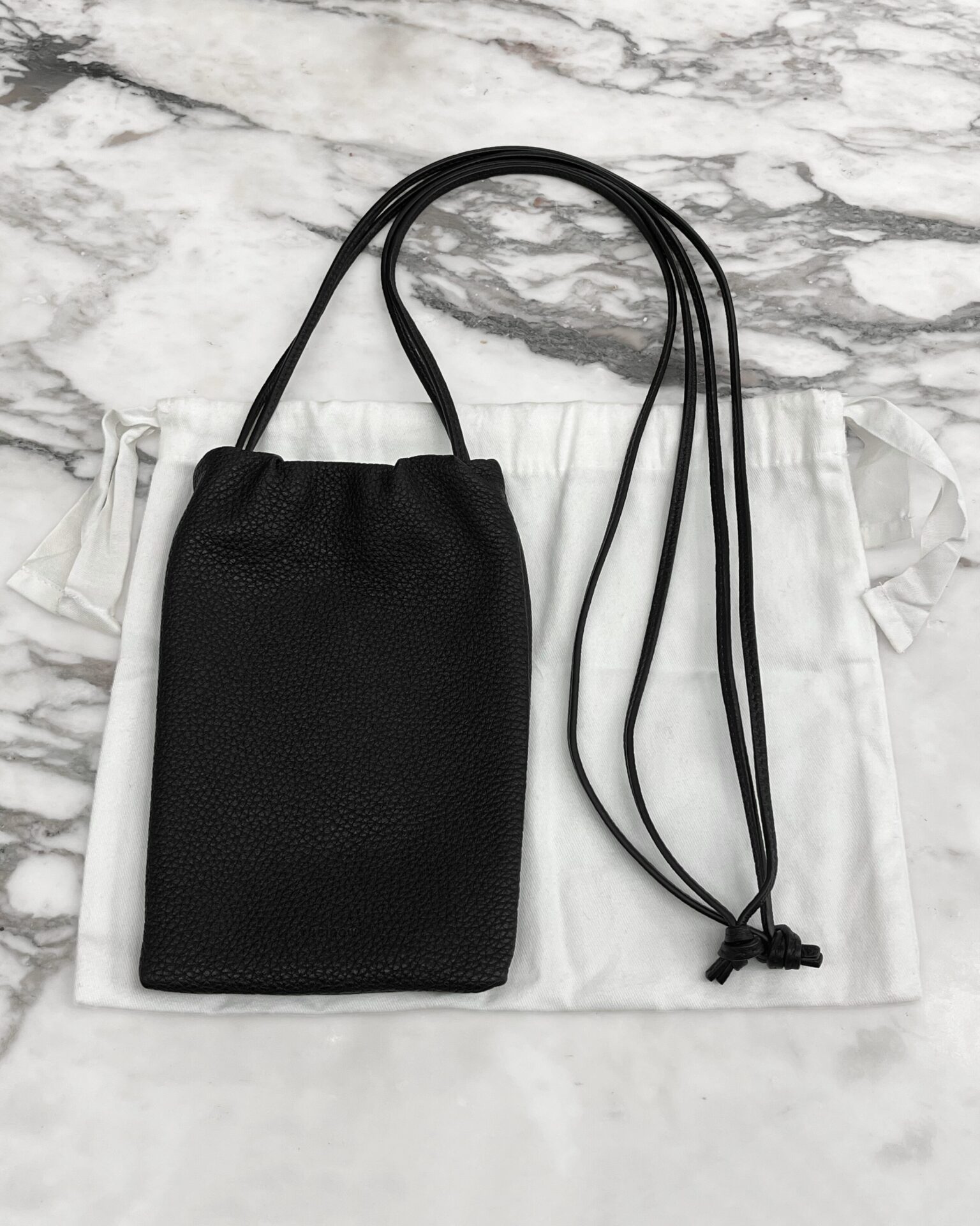 The Row Bourse black leather phone pouch