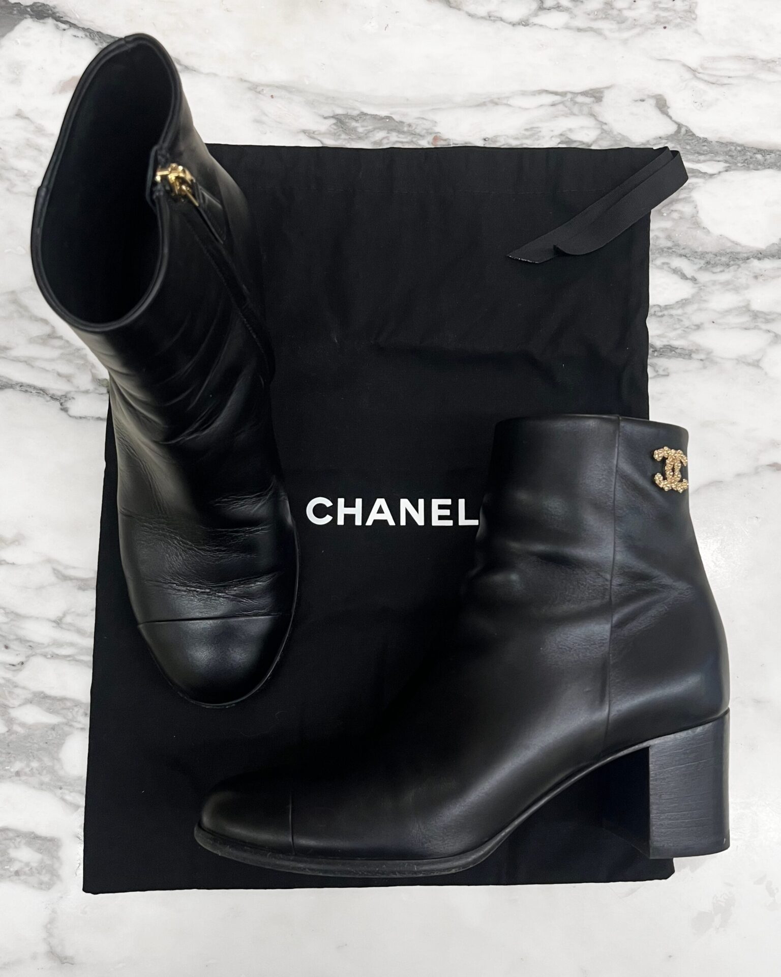 Chanel black leather boots with gold CC at ankle