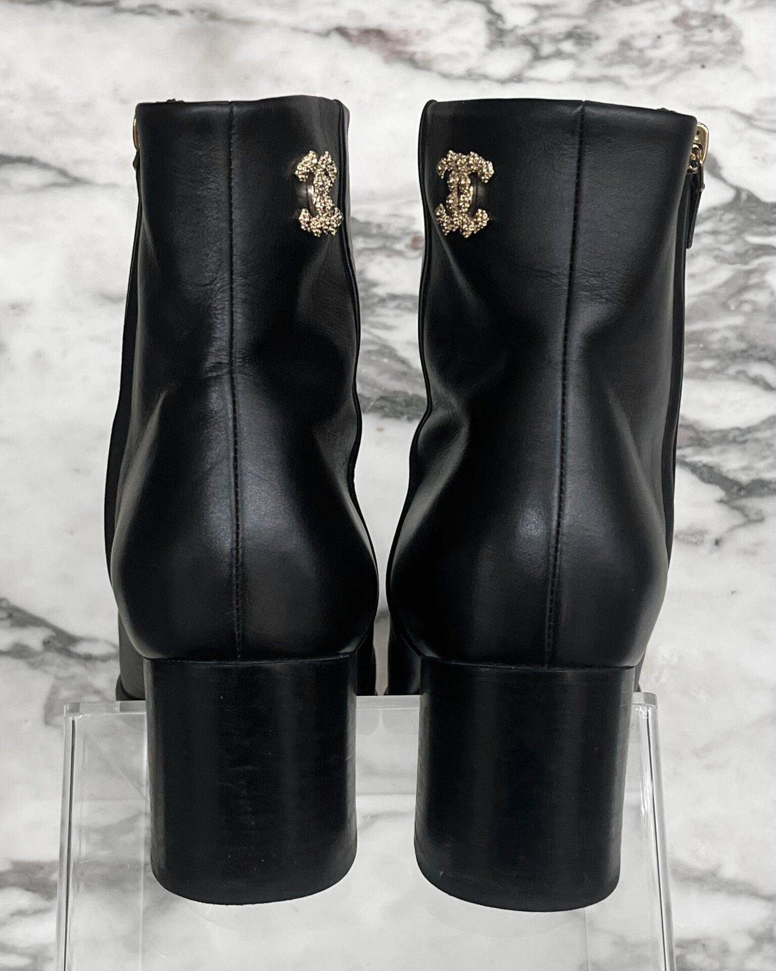 Chanel black leather boots with gold CC at ankle